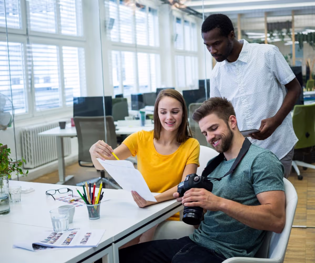 A group of employees looking at a camera together in an office